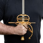 Closeup of someone holding Goldflare Dueling Rapier in hand.