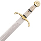 Detailed view of the bone handle with brass-colored metal alloy guard and pommel. 