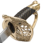 Close-up view of the detailing on the brass guard with ornate designs and wire wrapped handle. 