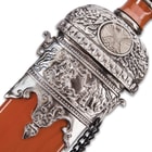 The ornate detailing of the guard lines up perfectly with that of the scabbard. 