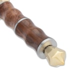 The ridged handle is of premium wood, bookended by a polished brass cross-guard and pommel with a skull crusher
