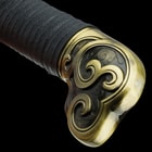 The handle is wood wrapped in black nylon cord and it features an elaborately designed, antiqued metal alloy pommel