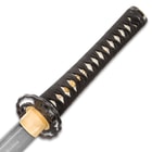 Zoomed view of katana handle showcasing brass habaki attached to custom cast metal tsuba extended to genuine rayskin handle
