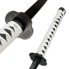 Detailed view of the black imitation ray skin handle wrapped in white nylon cord. 
