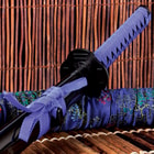 The black tsuba and purple cord wrapping of the scabbard and handle are shown laid on a tatami mat with ornamental cloth. 