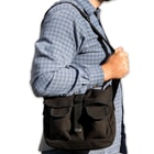 It’s made of black, 100 percent cotton canvas with an adjustable nylon webbing shoulder strap and metal fittings