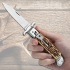 The Staghorn Automatic Stiletto Knife shown in hand for size reference