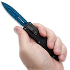 Close up image of OTF Knife held in hand.