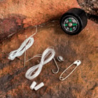 The knife’s handle houses a mini survival kit that includes a fishing line, a hook, needles and thread, and a safety pin.