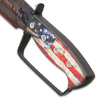 Upclose view of the knuckle buster style distressed American flag handle with black accents on the bowie knife.
