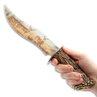 This image is of a hand holding the Deer Bowie Knife and pointing it upwards.