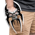 The Skull Reaver Hand Blade shown on someones hand.