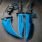 An angled view of the karambit, huntsman, and military knife laid side by side with blue metallic blades and black textured handles.