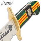 Timber Wolf's Limited Edition Vietnam Veteran Bowie Knife has a brass guard to complement the service ribbon themed handle