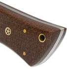 The attractive black and brown wooden handle scales are secured to the tang with brass pins and the handle has a brass lanyard