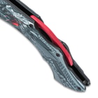 Close up image of the red spine on the handle of the Ridgeback Dragon Pocket Knife.