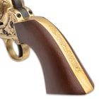 The .44 caliber, black powder pistol has an engraved solid brass frame with a 7 1/2” blued barrel and a wooden grip