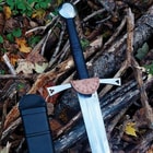 Angled view of the black leather wrapped handle with circular pommel and decorative guard accent.
