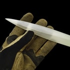 A hand is shown holding the knife’s blade, which is an exact replica of the movie blade that is crafted from razor-sharp sandworm teeth.