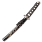 The tanto is shown with dragon design scabbard and black cord wrapped handle.