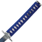 The wooden handle is wrapped in white, faux rayskin and bright blue cord and it has a decorative metal pommel