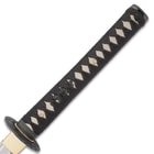 The katana's handle is traditionally wrapped in black cotton cord