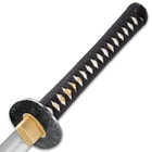 A close-up of the katana's cord-wrapped handle