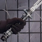 A gloved hand holds the futuristic looking handle of the Samurai 3000 sword. 