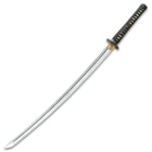 27 inch katana sword with T10 carbon steel blade displays a wooden handle wrapped with black cord over tea dyed rayskin
