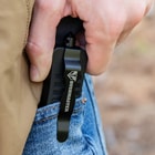 The all-black knife is shown with the black blade fully deployed from the front of the textured black handle.