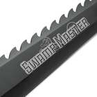“Swamp Master” is printed on the side of the black blade, beneath the “gator tooth” spine.