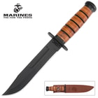 The USMC Combat Fighter Knife is housed in a brown leather sheath, embossed with the USMC logo.