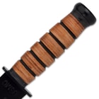 It has the classic stacked, genuine leather handle, recognizable the world over, and a black, non-reflective handguard