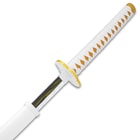 The sword’s blade with yellow lightning bolt is shown with white cord wrapped yellow faux ray skin handle and white scabbard.