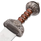 The circular, ornate pommel and guard are shown around the faux wood grip. 