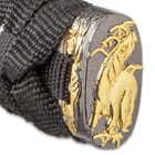 The pommel is detailed with a gold color design just above the black cord wrapped handle. 