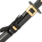 Sleek black aluminum scabbard shown with brass detailing and black intricated design.