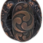 The hardwood handle is wrapped in genuine ivory-colored rayskin and black cord and the round tsuba has a gankyil design