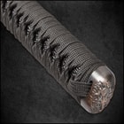 An antique finished tsuba and habaki with detailed dragon on fuchi showing the black rayskin wrapped in matching color cord
