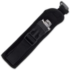 The black nylon belt sheath is shown unbuckled with the knife placed inside.