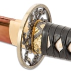 Zoomed view of brass collar fuchi where the genuine rayskin leather wrapped tsuka and blade meet
