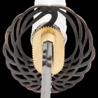 The handle is wrapped in gold-threaded cloth and white cord and has a cast metal pommel with a Samurai theme