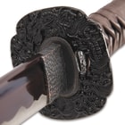 The dark metal alloy habaki has a reptile pattern and the dark metal alloy tsuba has an intricate Wind Dragon design
