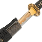 Sword drawn from black wooden scabbard with gold spiderweb designs showing the 1060 carbon steel blade with burned finish
