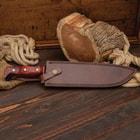 The Heart of Darkness Bowie Knife shown in its leather sheath