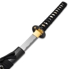 The hand-forged 1045 steel blade is shown sliding into the black scabbard. 