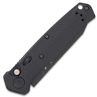 Closed all-black pocket knife with automatic opening and milled chevron G10 handle scales and lanyard hole. 
