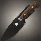 G 10 wood look handle and steel hand guard enclosed in black leather sheath with silver button closure. 

