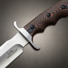 A close-up of the fixed blade's handguard and handle