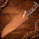 Knife in leather sheath on wooden background with rope